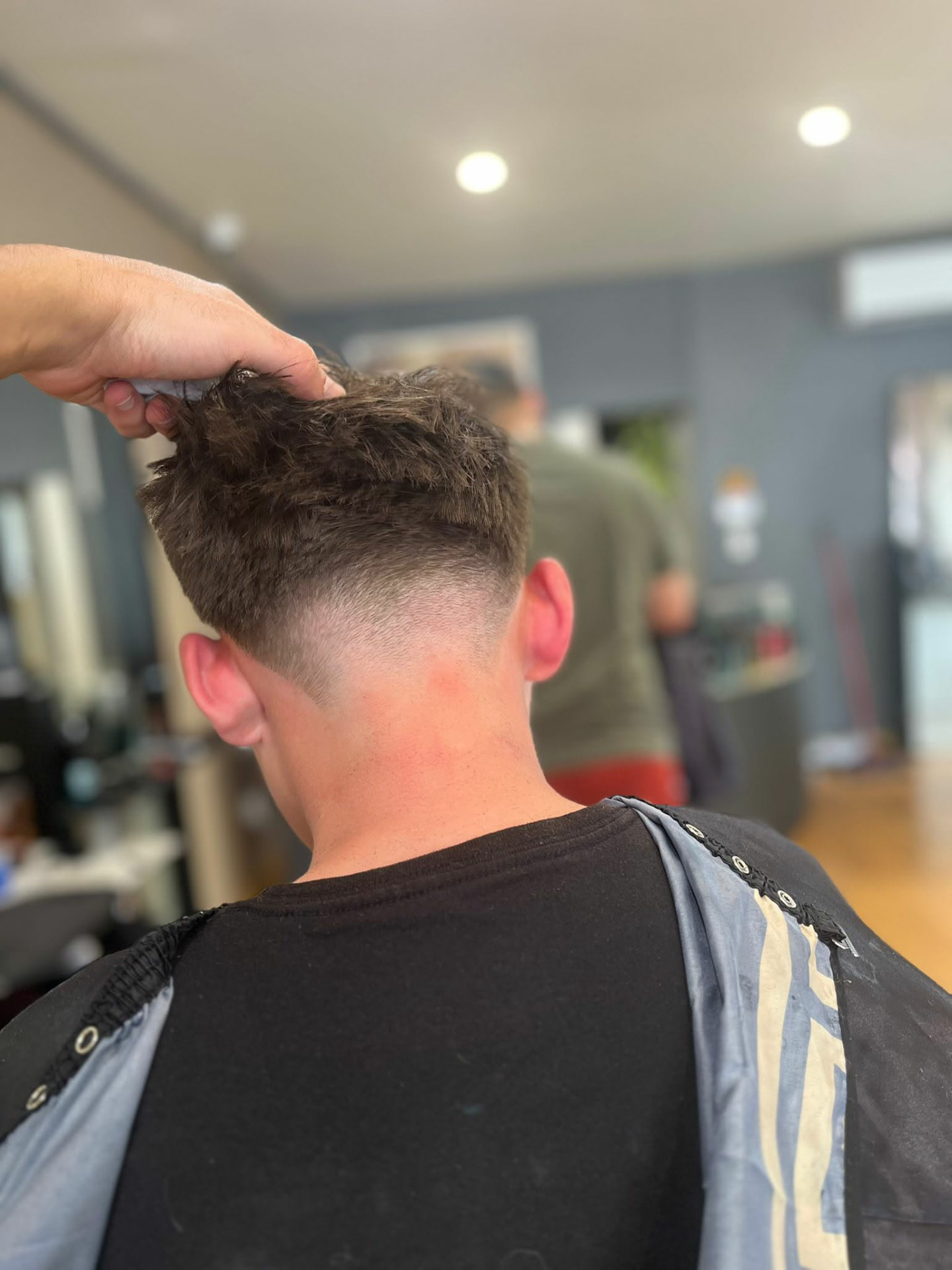 Textured crop with a high skin fade, finished at Castle Barbers